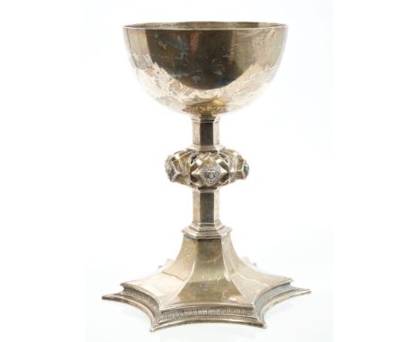 George V silver chalice of Gothic inspiration, with plain bowl, hexagonal stem with Gothic pierced knop and mask bosses, spla