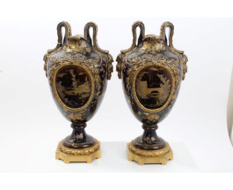 Pair 19th century French Choisy Le Roi vases with gilt and brown scroll handles, landscape reserves on blue ground with gilt 