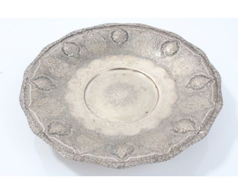 Eastern silver tazza with engraved Persian floral decoration and raised flower-head bosses, on a circular pedestal foot - und