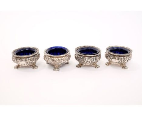 Set of four good quality George IV silver salts cast with floral decoration, on scroll feet - blue glass liners, hallmarked S