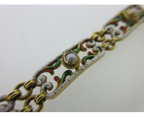 with seven pierced and scrolling links enamelled in clear green and red with opaque white edges with black dot decoration, ar