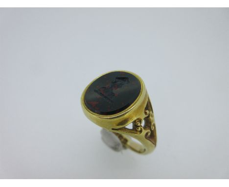 the armorial crest intaglio carved into the oval bloodstone, mounted in a sturdy collet to tapered shoulders pierced with tre