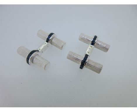 each uniform finely reeded baton bound around the centre with a ring of channel set calibré cut sapphires, fixed connections,
