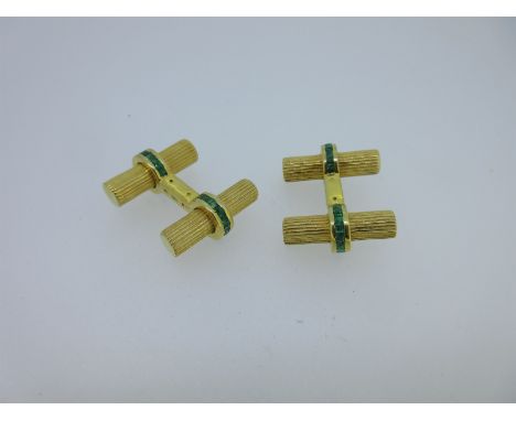 each of the four ends designed as a reeded bar of gilt metal bound around the centre by a ring of channel set calibré cut eme