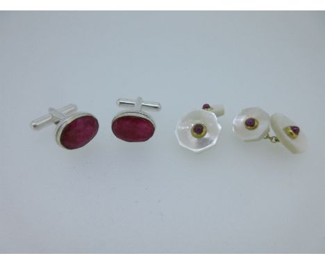 the first pair each with an oval faceted opaque ruby collet and closed back set, with tuning fork fixing holding a swivel bar