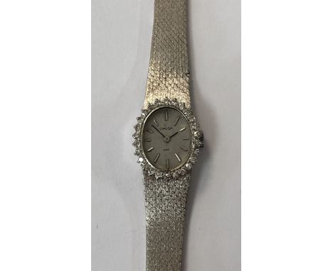 circa 1971, model 511.0363, the signed oval silvered dial with black batons and hands, the bezel claw set with a total of 26 