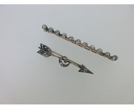 the bar brooch with a line of eleven uniform old round brilliant cut diamonds collet set and slightly spaced along a knife ed