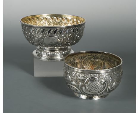 the first, with maker's mark erased, London 1805, of circular form lavishly decorated with repoussé scrolls and foliage over 