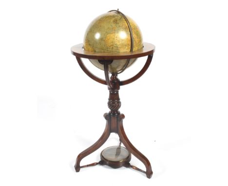 A contemporary Georgian style free standing globe. Mounted within a frame on a baluster rope twist column, raised on an out s