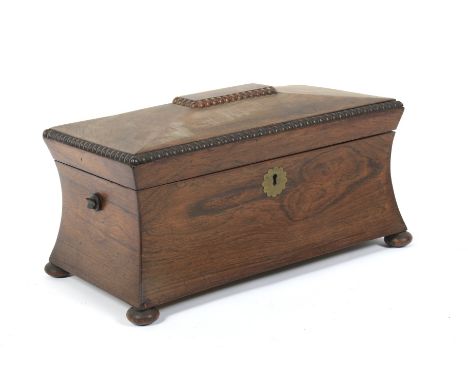 A William IV rosewood waisted rectangular tea caddy. With gadrooned rims and flowerhead shaped brass escutcheon, the hinged d