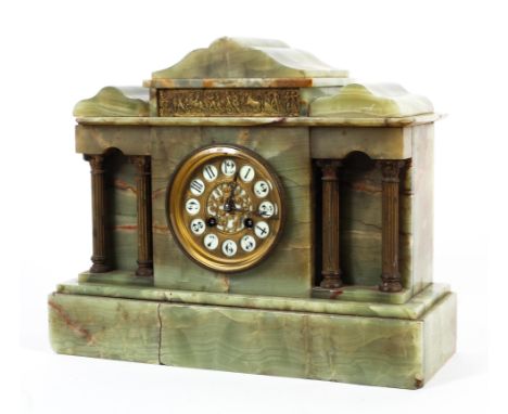A late 19th/early 20th century French onyx eight-day mantel clock. Of architectural form, the white ivorine Arabic numerals t