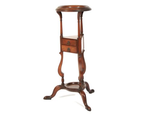 A Georgian mahogany wig stand. The circular dish top raised on turned supports to a triangular two drawer shelf above a circu