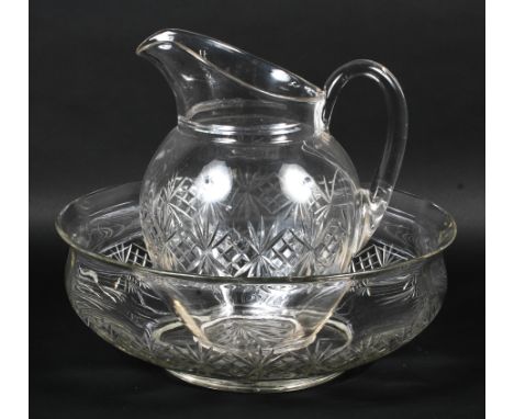A late 19th century cut glass water ewer and basin. Cut with bands of stars, with ewer with loop handle, the basin 39.5cm dia