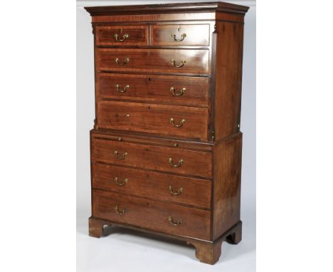 An early 19th century mahogany chest on chest. WIth moulded cornice above inlaid striped frieze, with two short drawers above