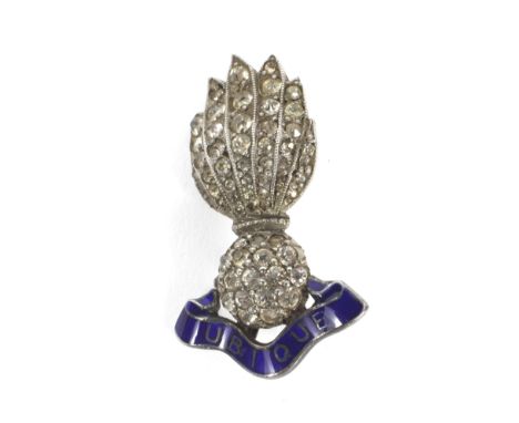A white metal Royal Artillery sweetheart brooch. Set with paste stones, above enamel banner reading 'Ubique', measuring appro