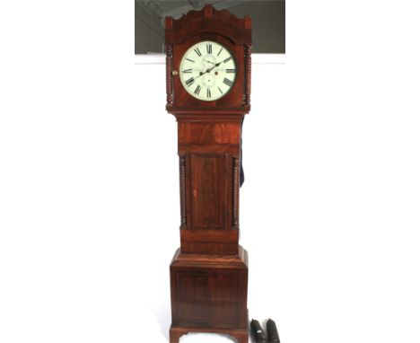 A 19th century mahogany cased eight day grandfather clock. With arched top above a circular glass hood flanked by rope twist 
