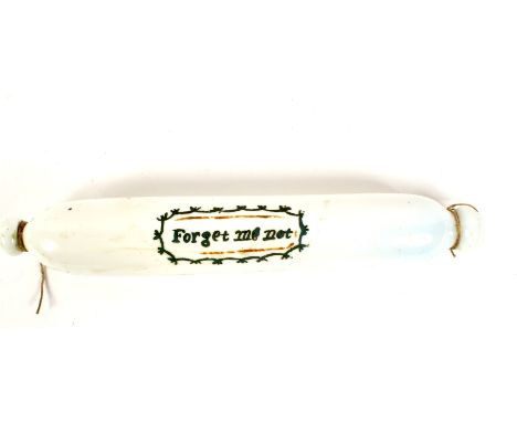 A Victorian opaque glass rolling pin of Nailsea type. Enamelled with the inscription Forgot me Not, within cartouche, 33.8cm 