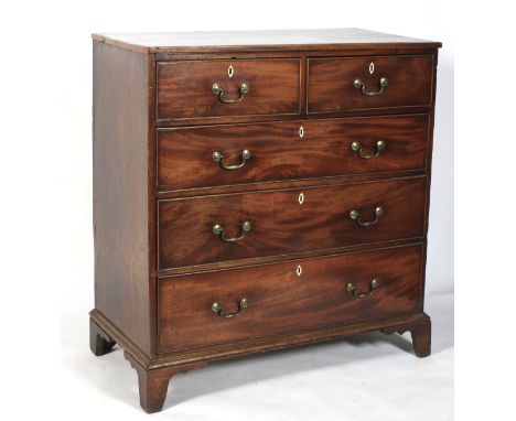 A Georgian mahogany chest of two short over three long graduating drawers. With bone escutcheons and brass handles raised on 