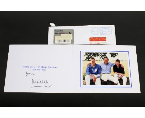 An HRH Charles Prince of Wales signed 2002 Christmas Card. The signature autopen machine generated, mounted with a colour pho