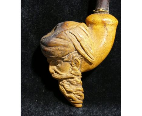 A 19th century Meerschaum pipe, the bowl carved with the head of a bearded man, 9cm high, the pipe 26cm long, a&nbsp;large as