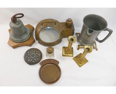 A brass casing for a ship's compass with glass front and oil lamp, a pair of 19th century brass candlesticks, two brass trive