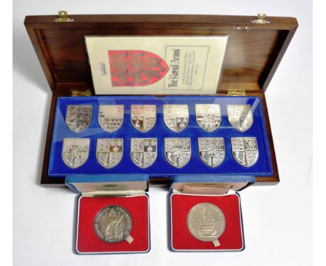 The Royal Arms, a set of 12 silver shield shaped ingots depicting the different Royal Arms as used from Richard I to the pres