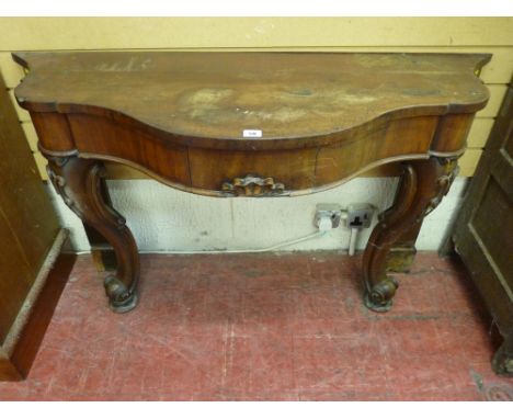 A VICTORIAN MAHOGANY HALL CONSOLE TABLE having a shaped top over a single central frieze drawer on carved shape front support