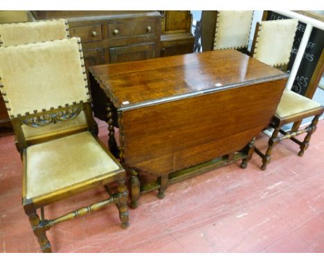 AN OAK BARLEY TWIST GATE LEG DINING TABLE with piecrust edging, along with a set of four oak dining chairs (non-matching) hav