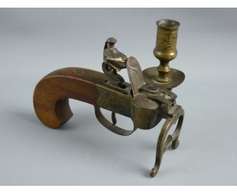 A FLINTLOCK TINDER PISTOL TABLE LIGHTER with candle sconce, 13.5 cms long, no visible markings but possibly Dunhill