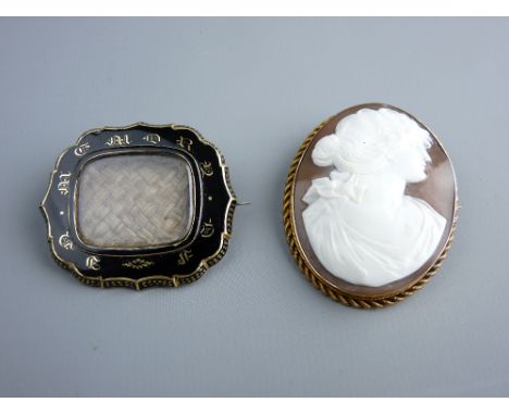 A VICTORIAN MOURNING BROOCH with central plaited hair panel in a black enamel and gilt metal mount, inscribed to the back, da