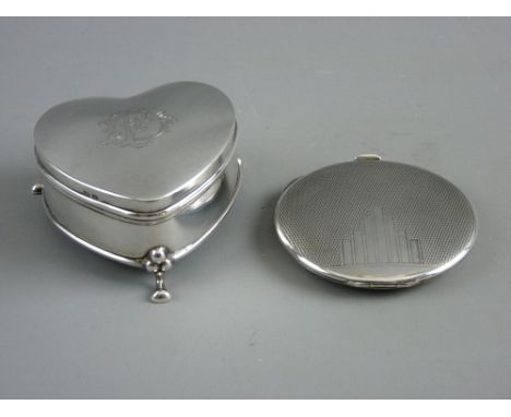 A HEART SHAPED TRINKET BOX and an Art Deco compact, the lidded box standing on three hoof feet, monogrammed to the top, Birmi
