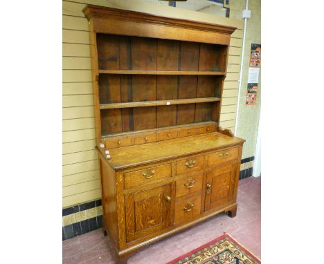 A COUNTRY OAK & PINE FARMHOUSE DRESSER, the three shelf wide boarded rack with blind spice drawers to the base, a lower 'T' a