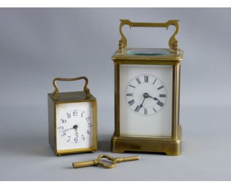 TWO FRENCH BRASS CASED CARRIAGE CLOCKS, the larger with white enamel dial set with Roman numerals, the movement striking on a