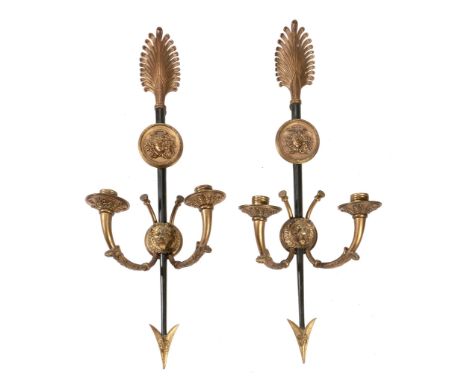 A pair of patinated and gilt metal twin light wall appliques in Empire style  A pair of patinated and gilt metal twin light w