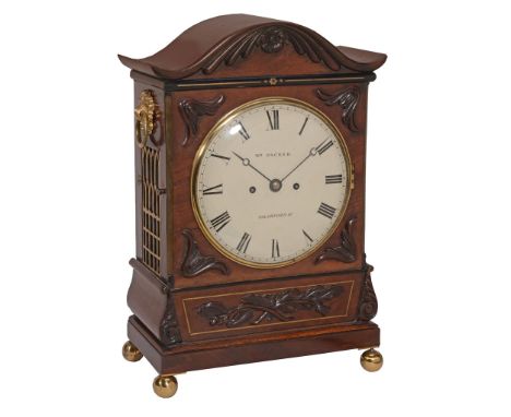 A William IV brass inlaid carved mahogany bracket clock  A William IV brass inlaid carved mahogany bracket clock, the dial in