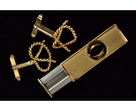 TWO ITEMS TO INCLUDE, a 9ct gold cigar cutter, engine turned, measuring approximately 52mm x 17mm, hallmarked 9ct gold, Birmi