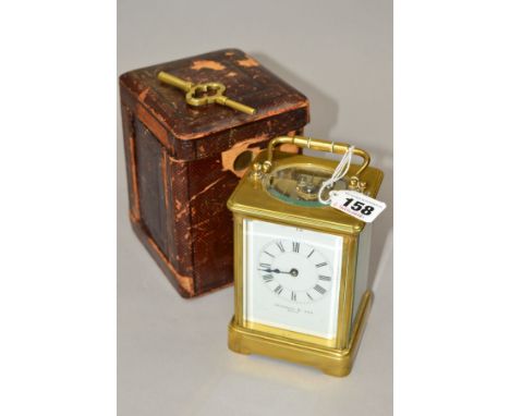 AN EARLY 20TH CENTURY BRASS CARRIAGE CLOCK, enamel dial with Roman numerals, names 'Jackman &amp; Son, Bath', gong strike, he