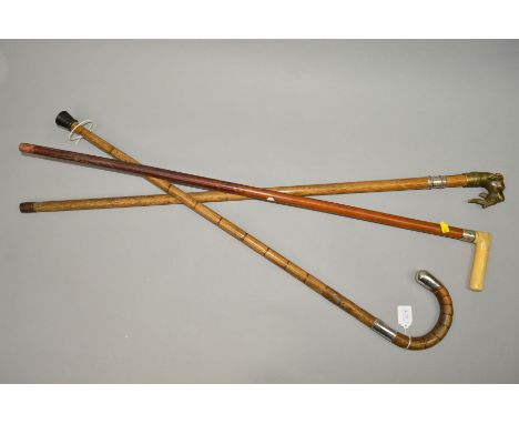 A GEORGE V SILVER MOUNTED WALKING STICK, together with two walking canes (3)