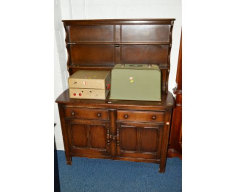 AN ERCOL DARK OAK DRESSER with two drawers, width 123cm x depth 45cm x height 160cm