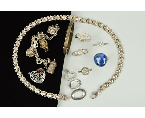 A SELECTION OF SILVER AND WHITE METAL JEWELLERY to include an expandable child's bangle, a charm bracelet, a necklace, rings,