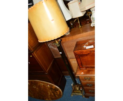 AN EDWARDIAN BRASS COLUMN STANDARD LAMP on square base and four claw feet, with a shade