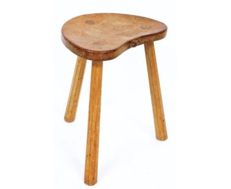 A Robert Thompson of Kilburn 'Mouseman' oak three legged stool, with shaped seat with carved mouse, on three taper legs, 45cm