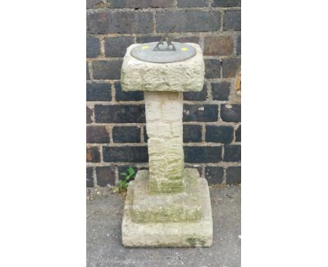 A reconstituted stone sundial, with stone effect detailing with metal sundial centre, 70cm high, 27cm wide.