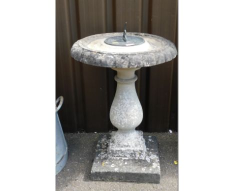 A reconstituted stone birdbath and sundial, the circular top with birdbath outer border, and central applied sundial on a pli