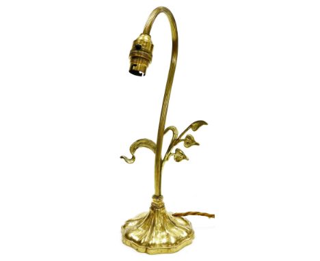 An Art Nouveau style brass table lamp, with curved top with leaf scroll branch decoration, converted to electricity, 36cm hig