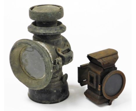 A railway inspection lamp, black metal, 22cm high, and a smaller brass example possibly for a bicycle, 12cm high. 