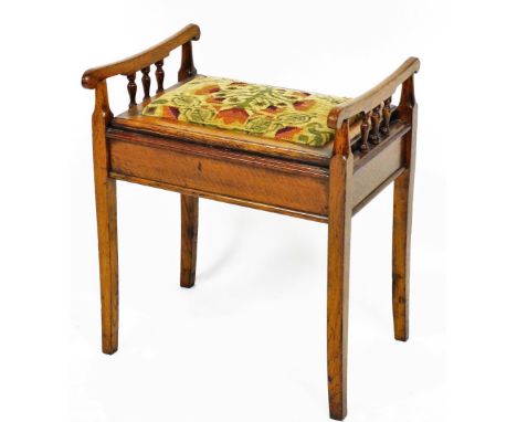 An oak piano stool, with tapestry upholstered seat, and lift up lid storage section, 60cm high, 51cm wide, 40cm deep. 