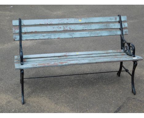A cast metal garden bench, with blue painted wooden slats and black painted ends, 72cm high, 122cm wide, 42cm deep.