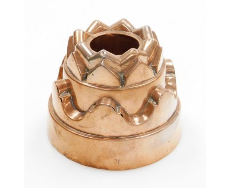 A Victorian copper jelly mould, with castle top and fluted borders, bearing the stamp M to the base, 12cm high, 15cm wide.