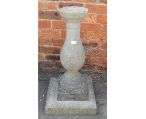 A reconstituted stone sundial, lacking top on a large rectangular block base, 81cm high, 42cm wide.